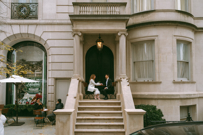 bride and groom sitting at a table outside in nyc shot by Elsie Goodman Photography | NYC Elopement Packages
