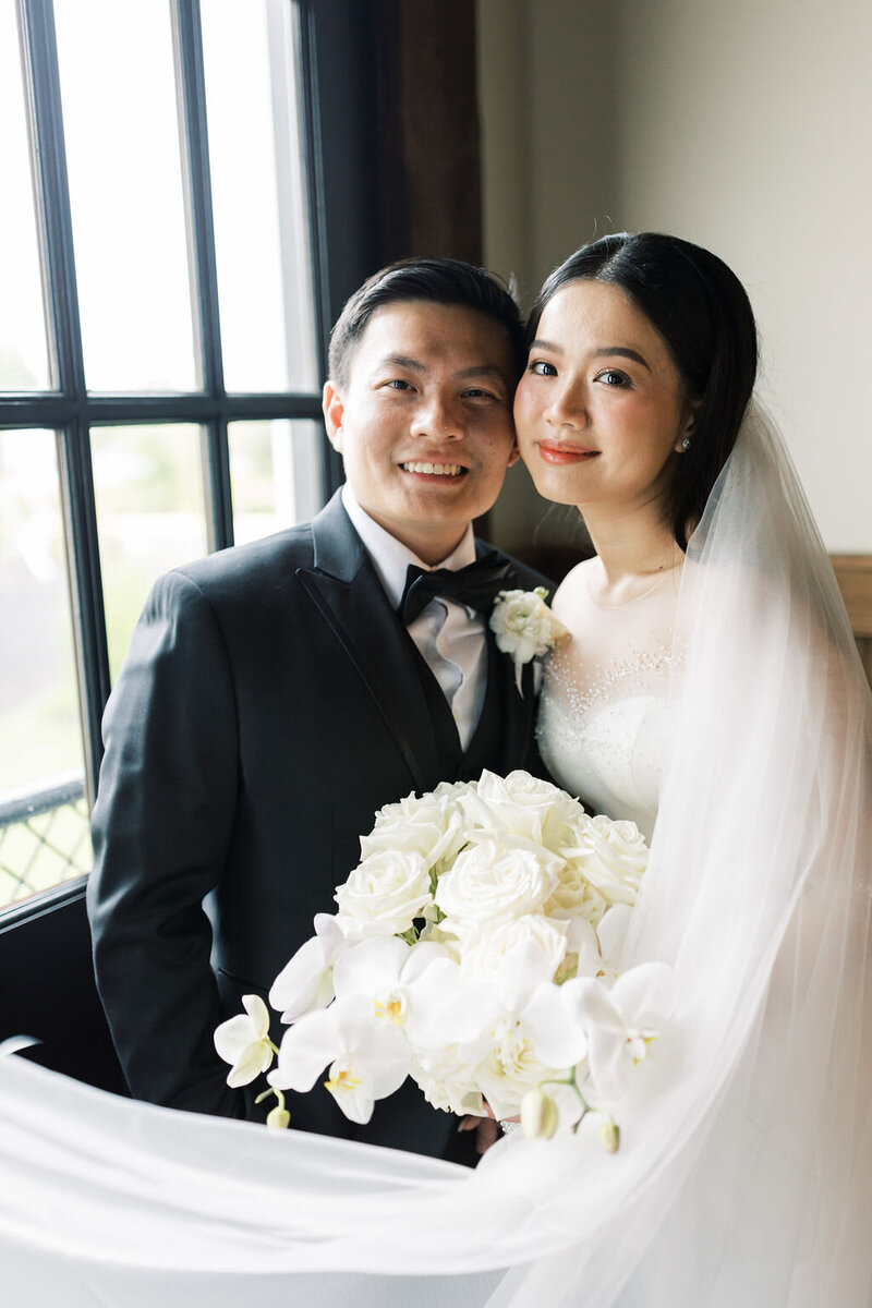 Bride and groom smile for wedding portraits at the Sweeney Barn