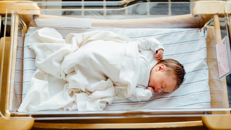 newborn baby laying in bassinet at hospotal