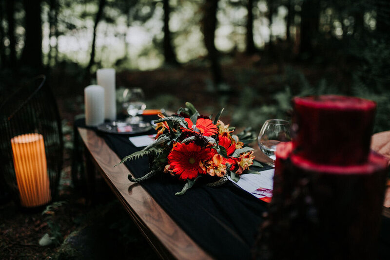 Florals, candles, and table placements on an outdoor table