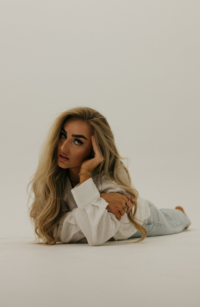 A woman smiling at the camera in an outside setting during Fall in Idaho Falls, ID.