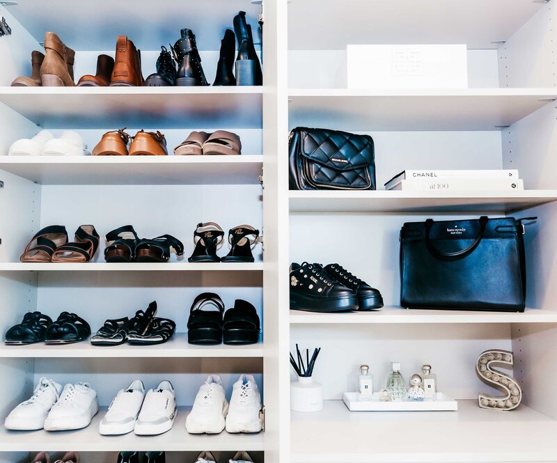 A bedroom closet featuring neatly placed shoes and handbags