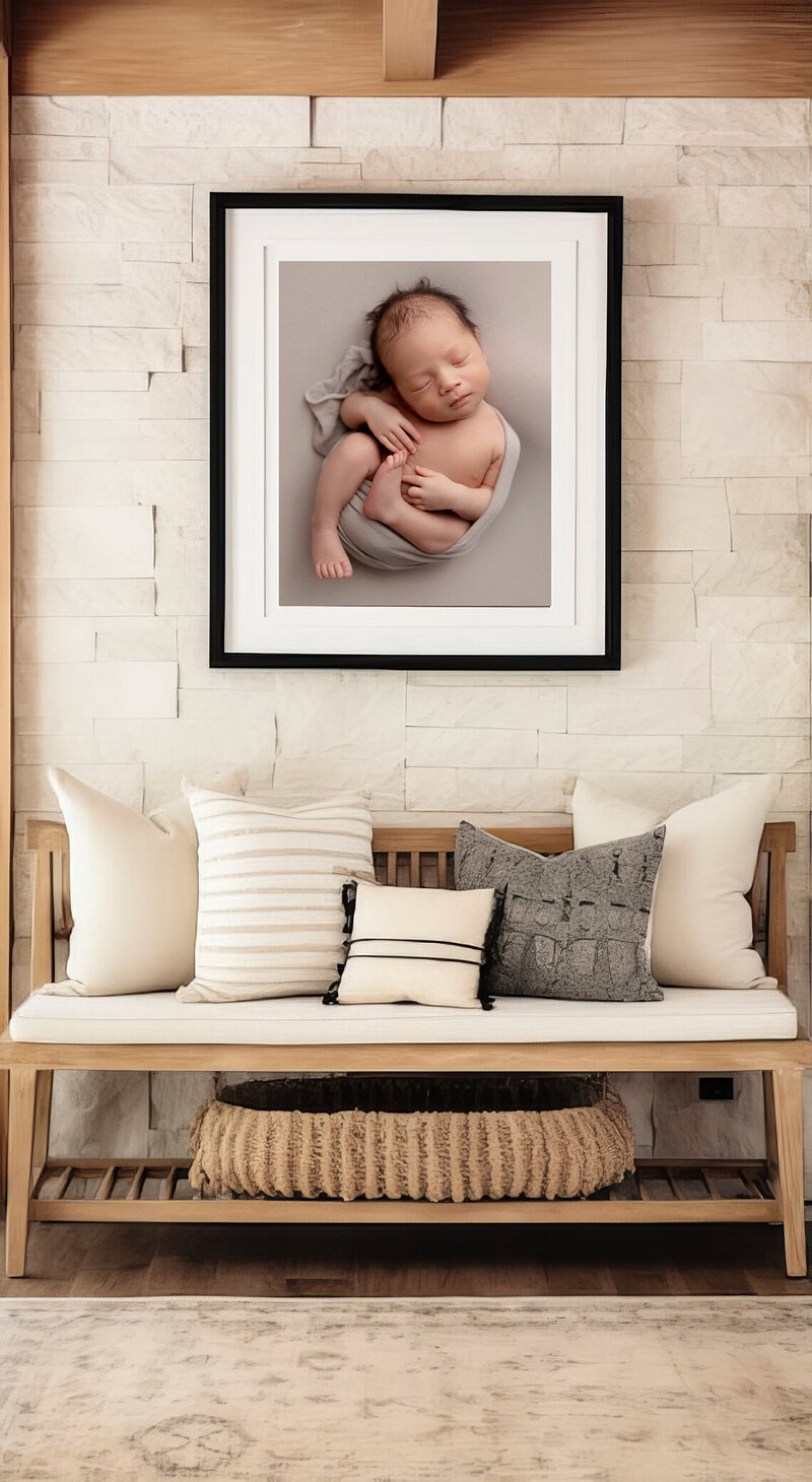 Framed portrait of a newborn baby  loosely swaddled and posed on his back