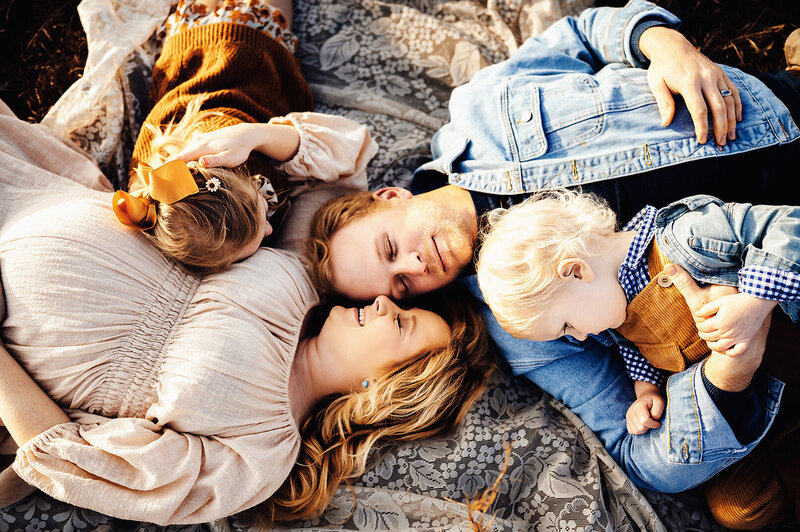 Bowling Green Ky Family photographer. Family of 4 lying on a blanket snuggling.
