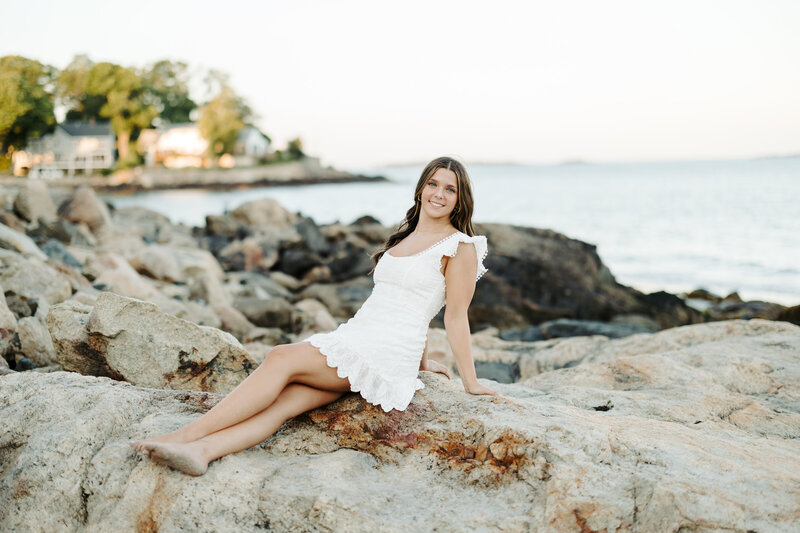 Senior girl smiles during fall senior session in Beverly, Massachusetts