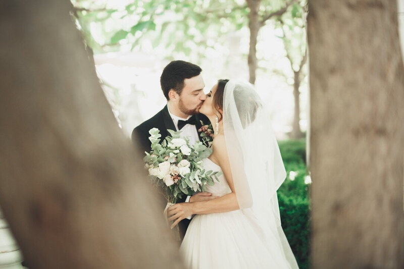 Bride and groom outdoors celebrating their summer wedding.