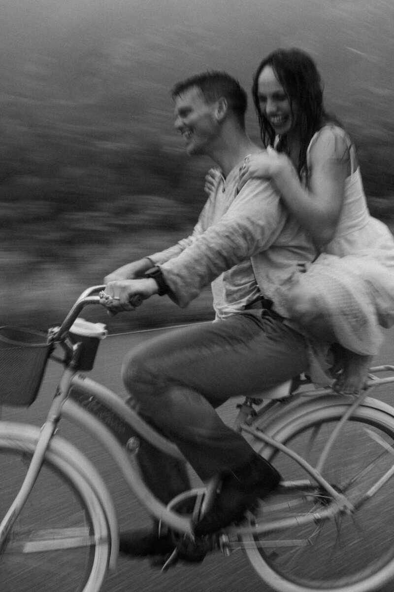 couple-riding-on-a-bike-in-the-rain