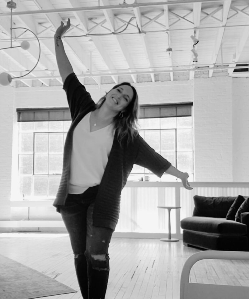 Julie from P&W Designs lounging on a couch with laptop, playful shot for Pinterest marketing guide page.