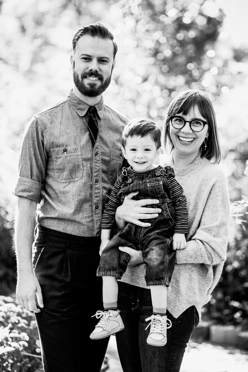 black and white photo of parents holding young boy