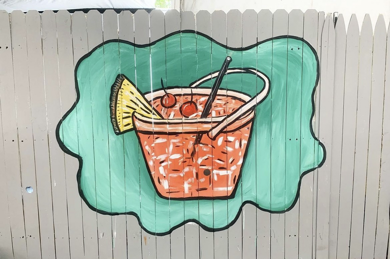 mural of drink on fence