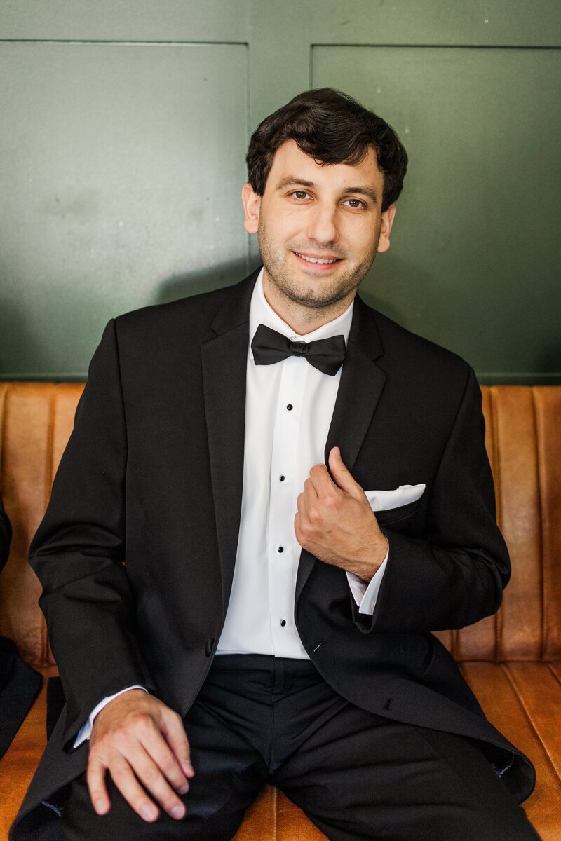 groom posing in his tuxedo
