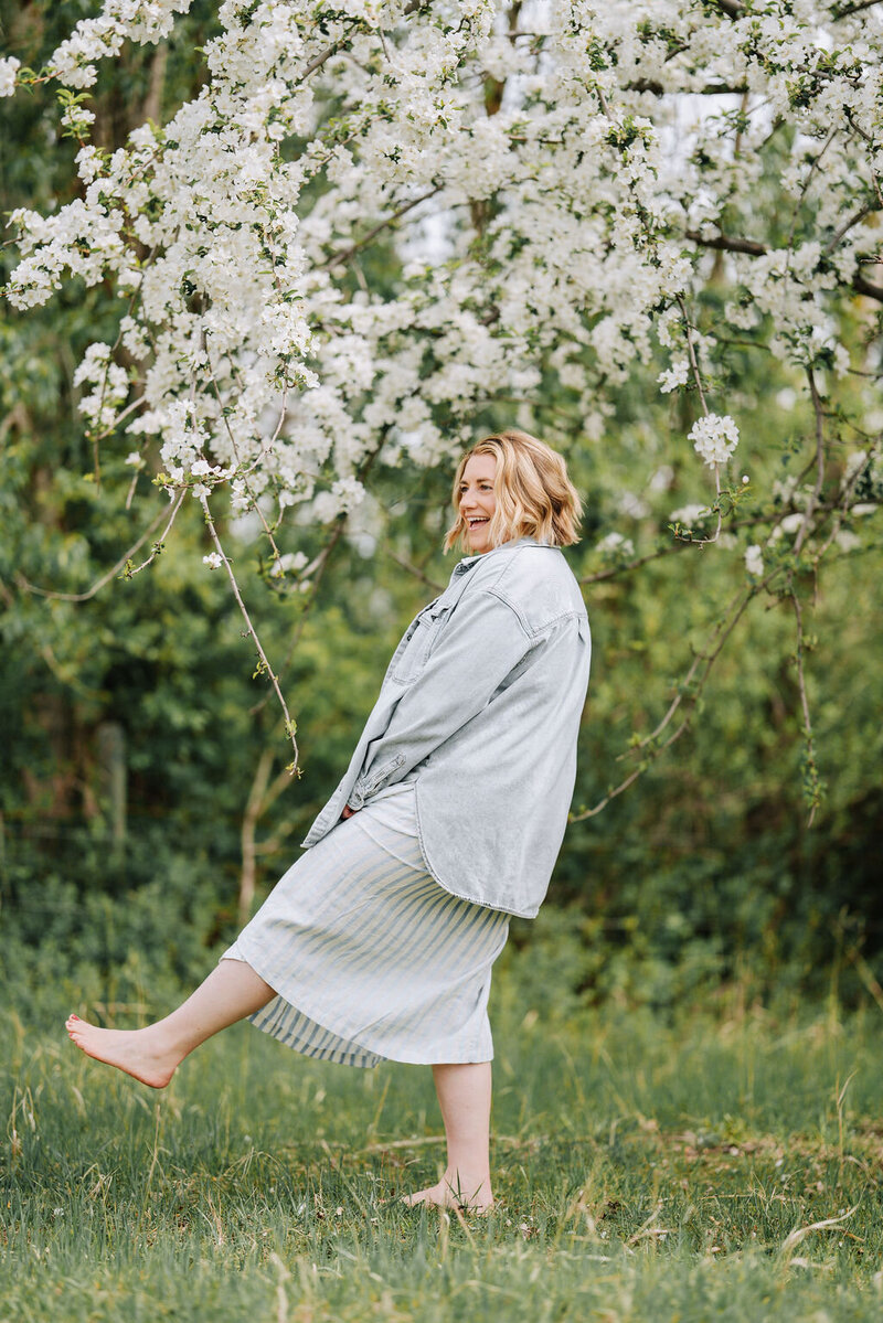 Graphic, web and branding designer Bess Brownlee smiles outside in Missoula, Montana.