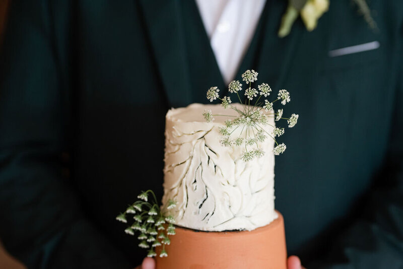 textured wedding cake with simple floral accents