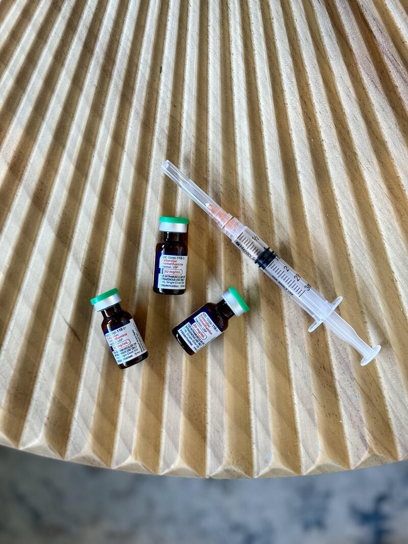 Three Tradole vial next to a syringe filled with a clear liquid