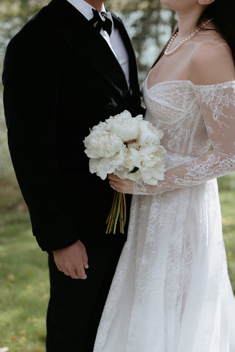 A woman placing her hand on a man's face during a wedding in Homer, Alaska.