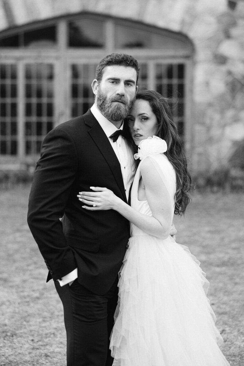 a bride and groom posing for a romantic portrait