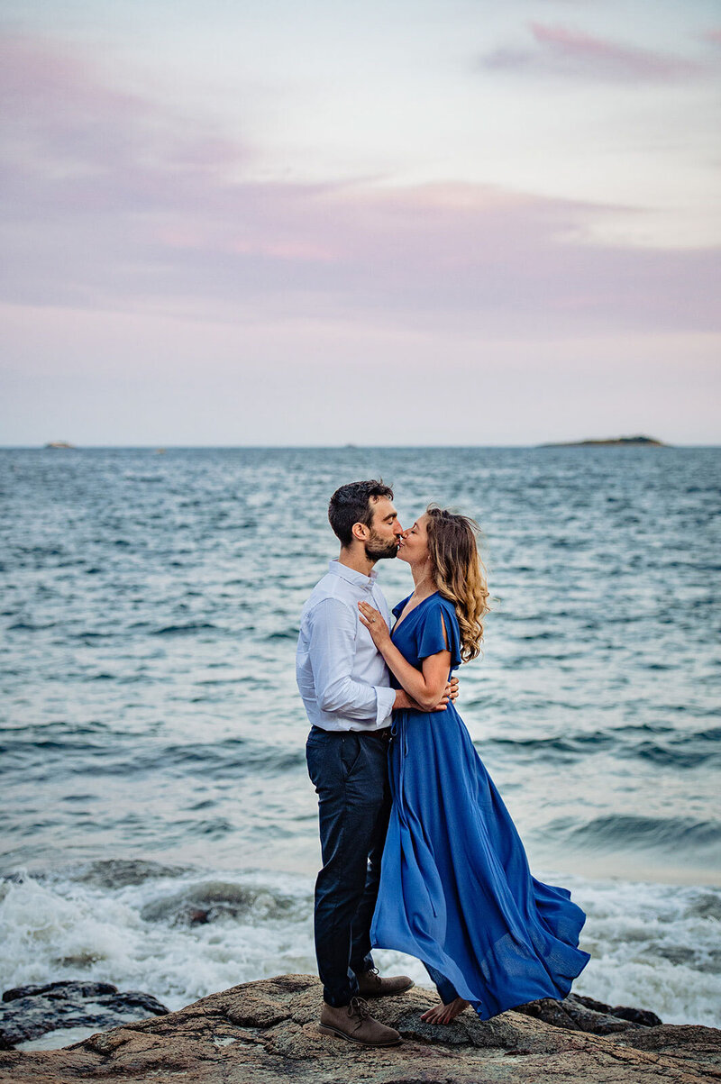 endicott college engagement couple on the rocks by the ocean