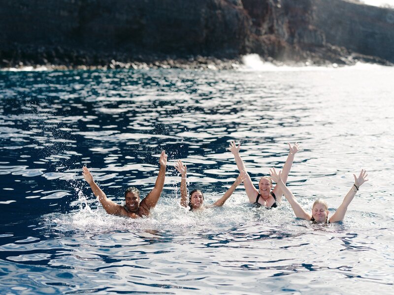 Fallon and her friends swim on a beach in Lanai, Hawaii