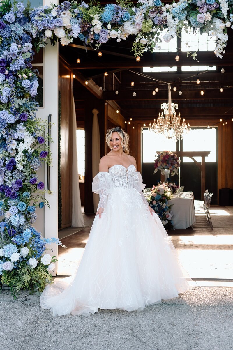 Bride with large purple and blue floral installation