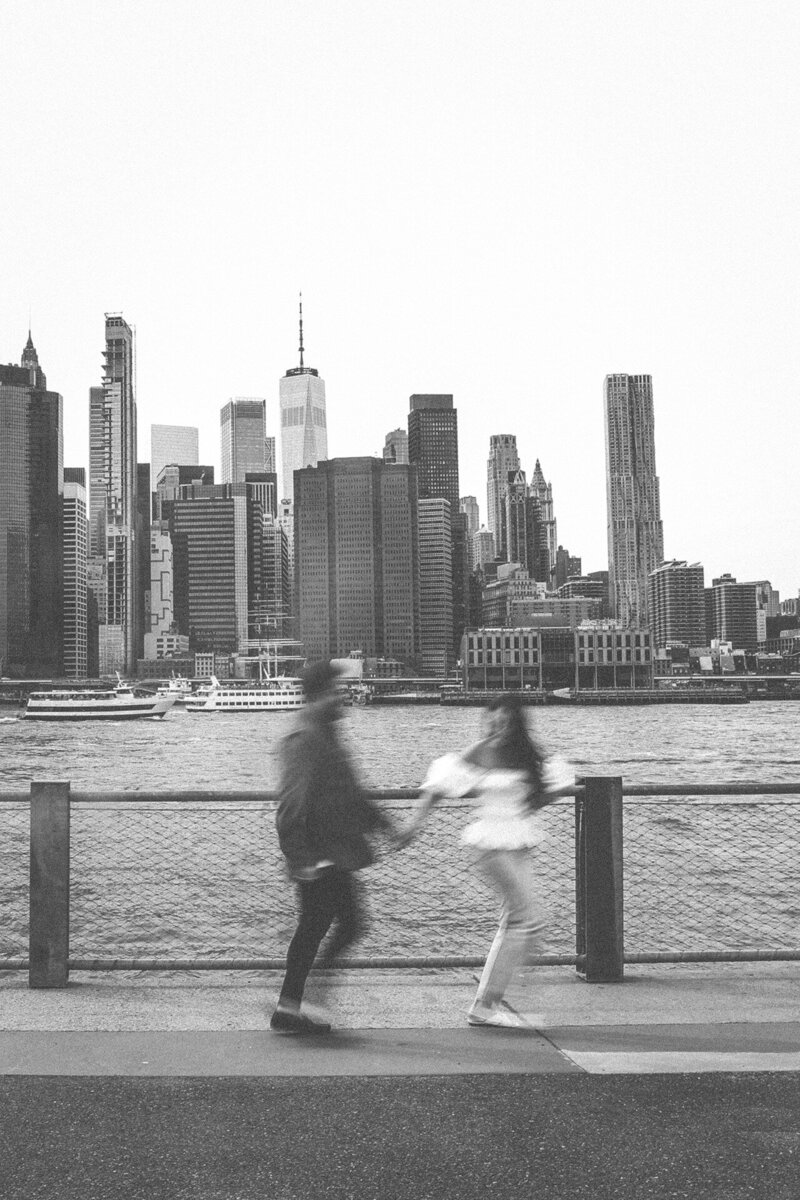 engaged-couple-city-behind-them