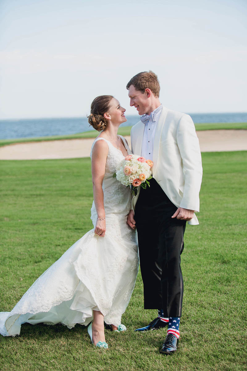 Bride and groom pose together on golf course, Rehoboth Beach Country Club, Delaware