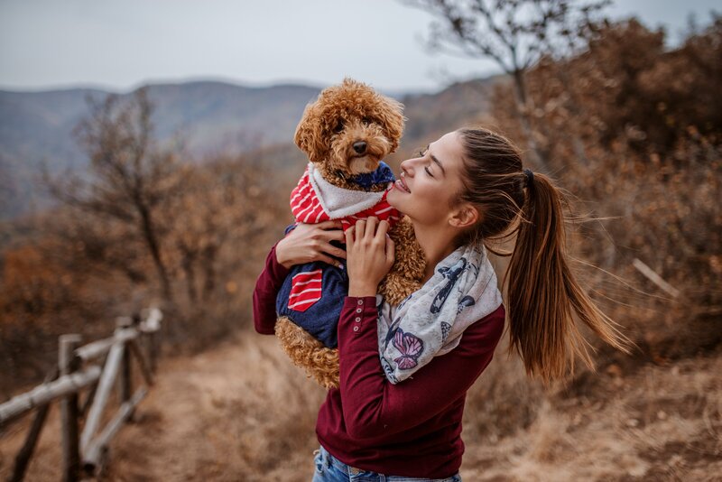 Woman holding mini poodle