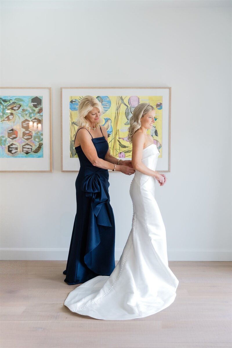 Bride getting dressed with her mom at the Alfond Inn in Winter Park.