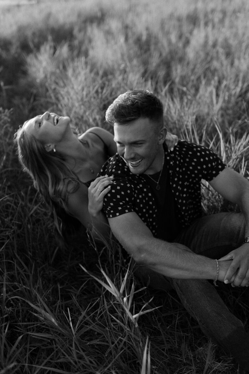 Couple share a candid, playful moment on a Minnesota summer's day. 