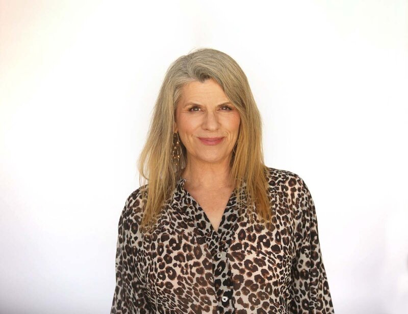 Julie Steelman Life Coach in a turquoise shirt smiling softly