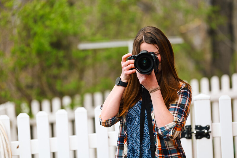 girl holding camera and looking thru