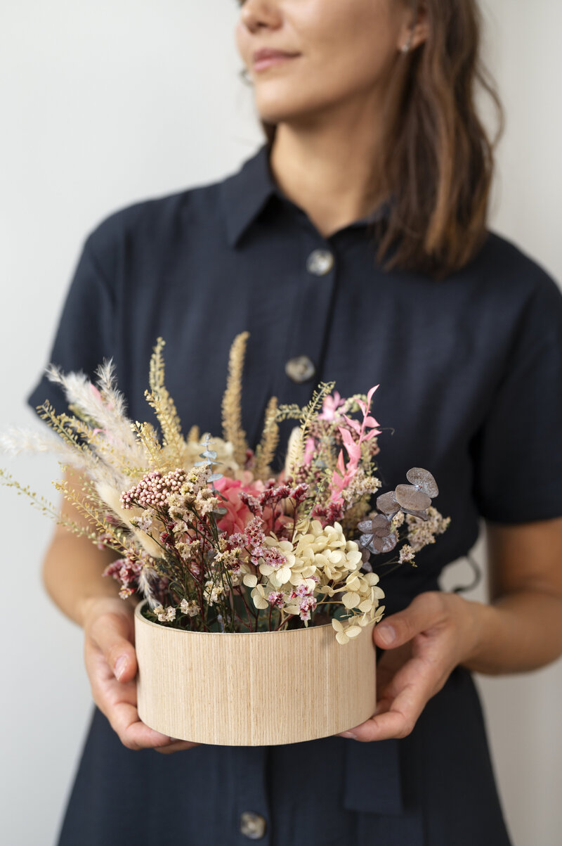 front-view-smiley-woman-holding-flowers