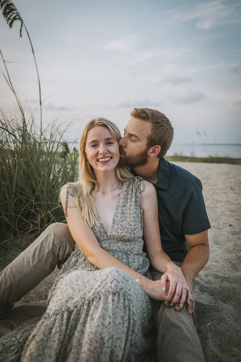 couple sitting on the beach at hilton head engagement session