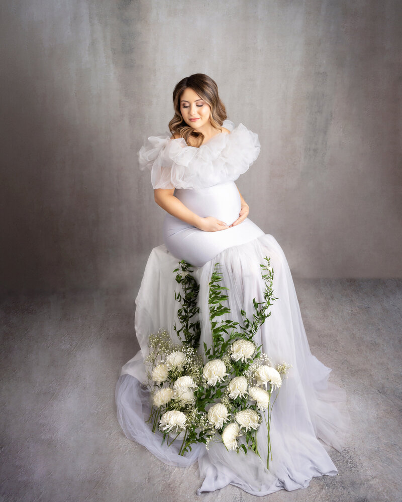 Gray studio New Orleans white flowers tulle baby bump vines
