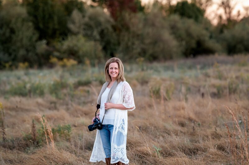 photographer holding camera in field