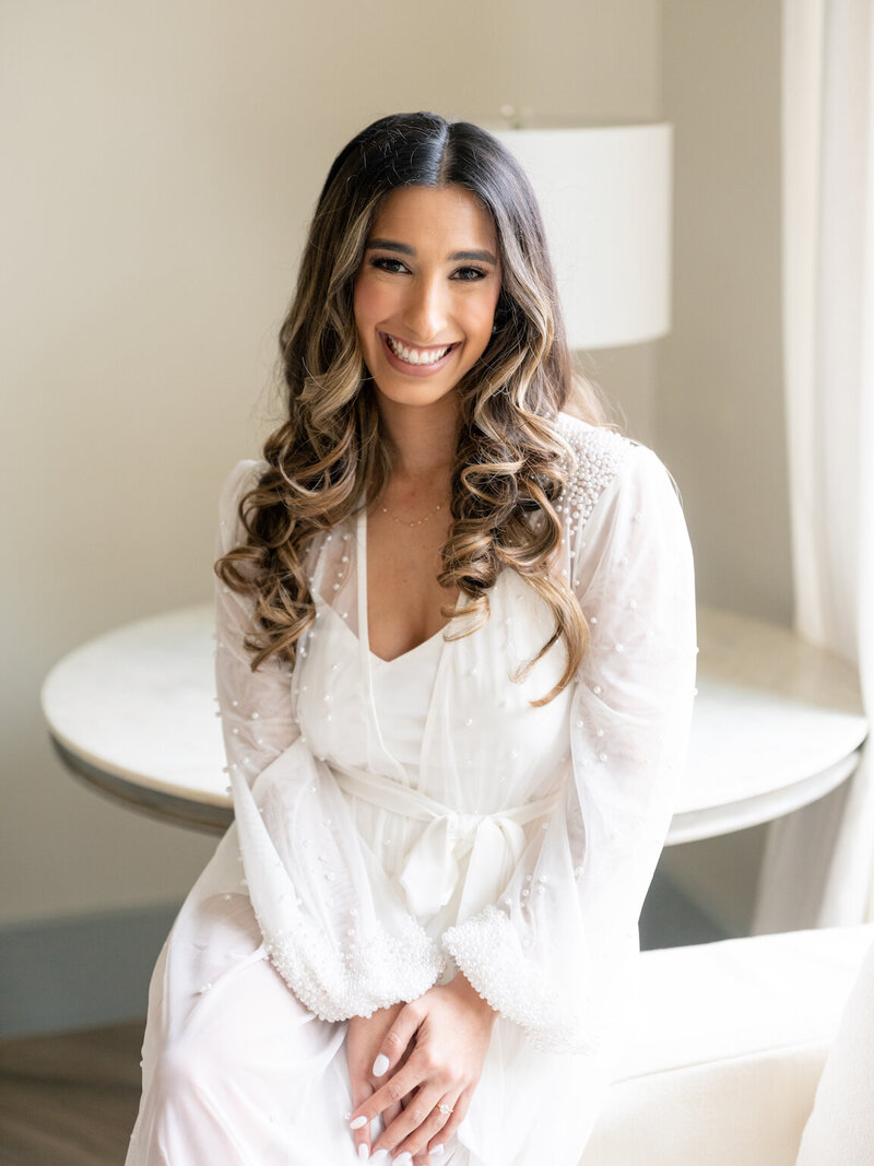 Bride getting ready in Canyonwood Ridge bridal suite with natural light and soft details