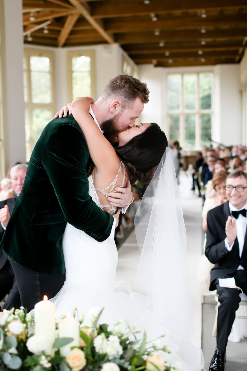 bride-and-groom-kissing-at-luxury-wedding-at-highcliffe-castle-in-dorset