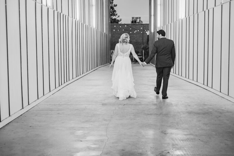 bride and groom walking black and white image