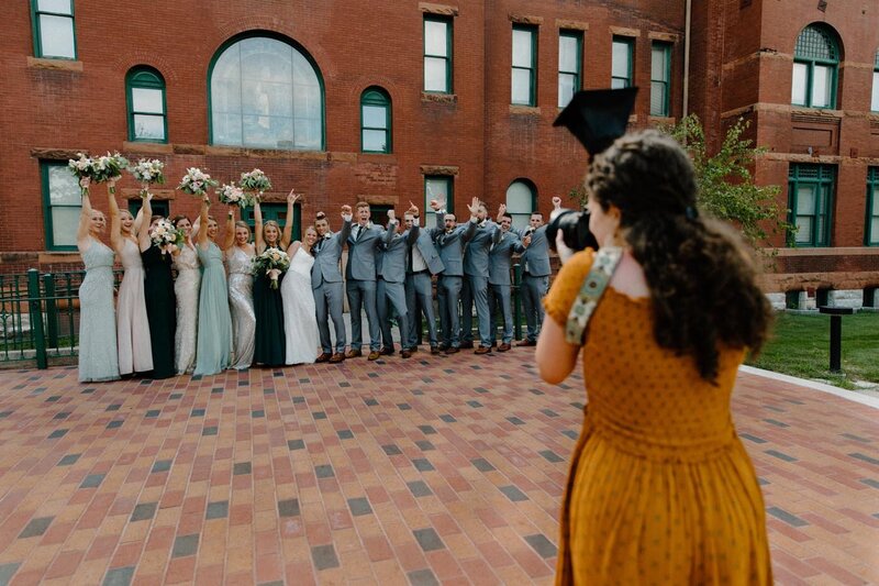 photographer taking picture of bridal party