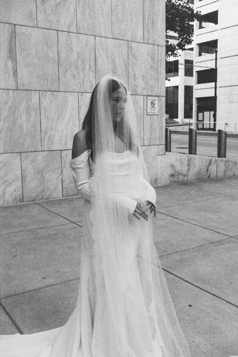 black and white photo of  bride with veil over her face