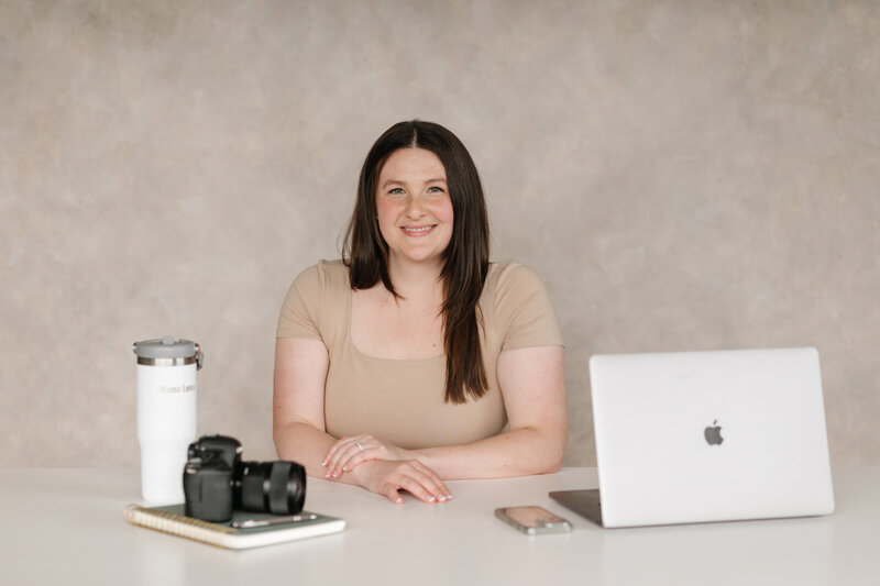 Lena, a family and infant photographer sitting with her things