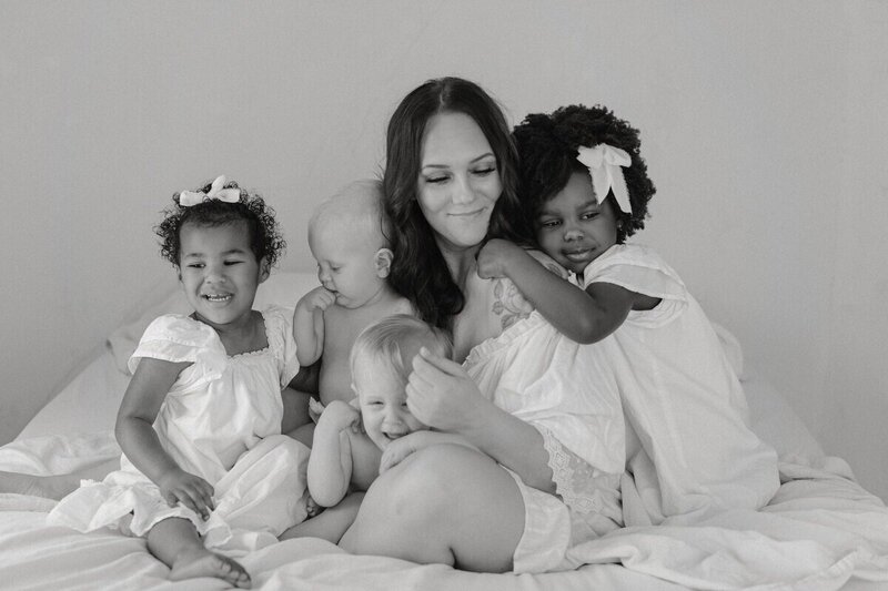 Mother surrounded by four children in soft black and white portrait by a Michigan photographer