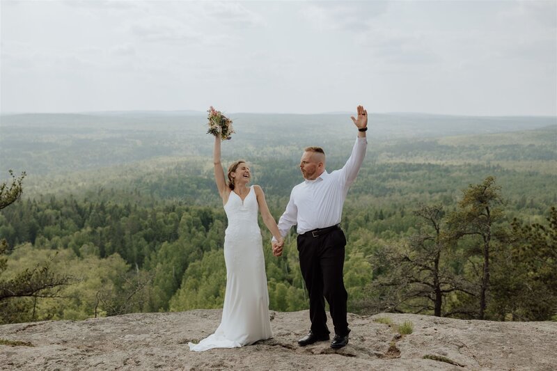 bride and groom eloping on the north shore and celebrating on a rocky overlook in the lusten mountains