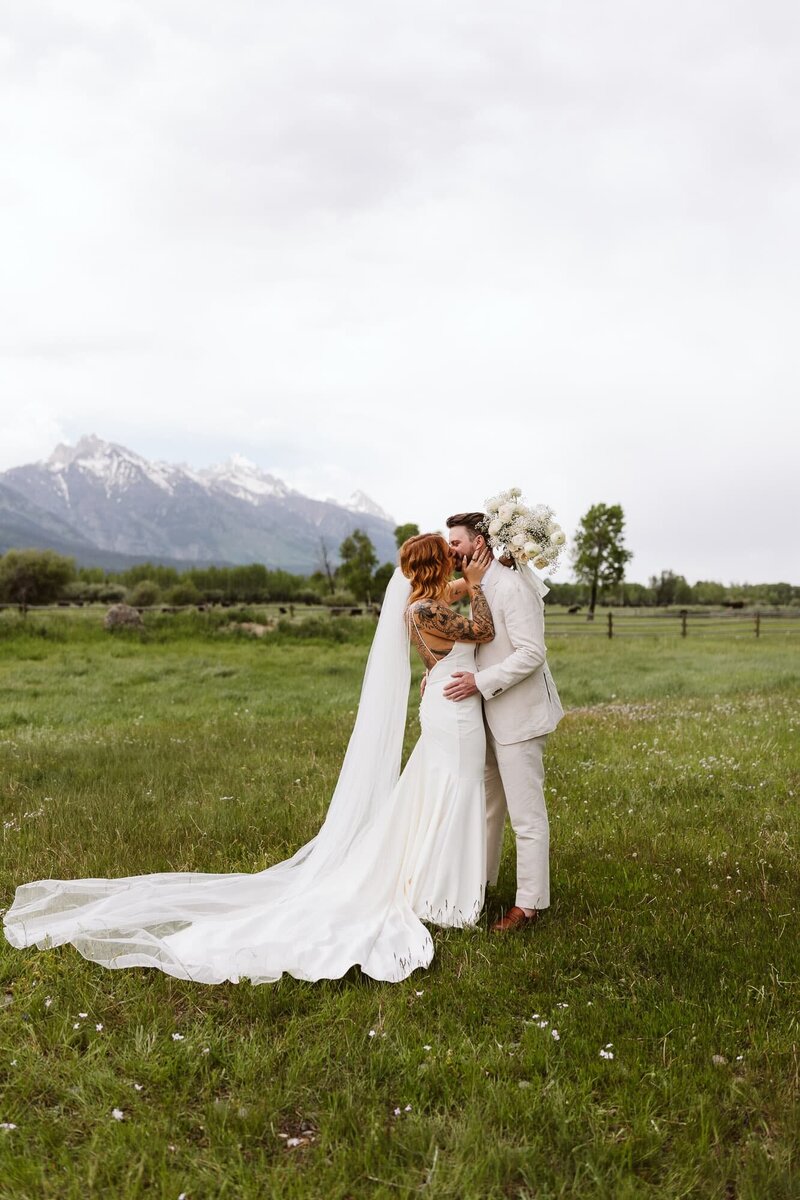 A bride and groom's first kiss during their luxury wedding in Jackson Hole Wyoming