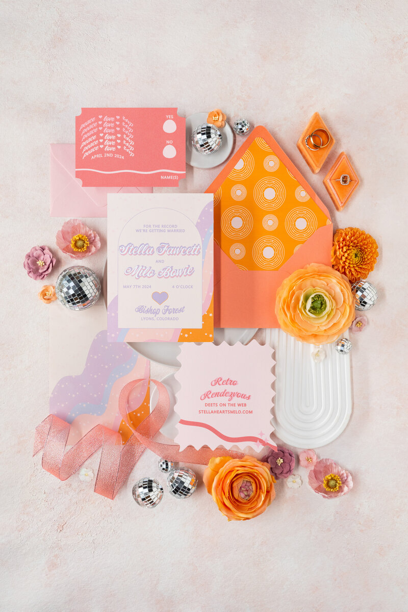 A retro themed wedding invitation suite with record place cards.