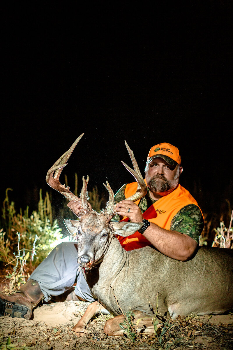 central Kansas whitetail hunter admiring his deer