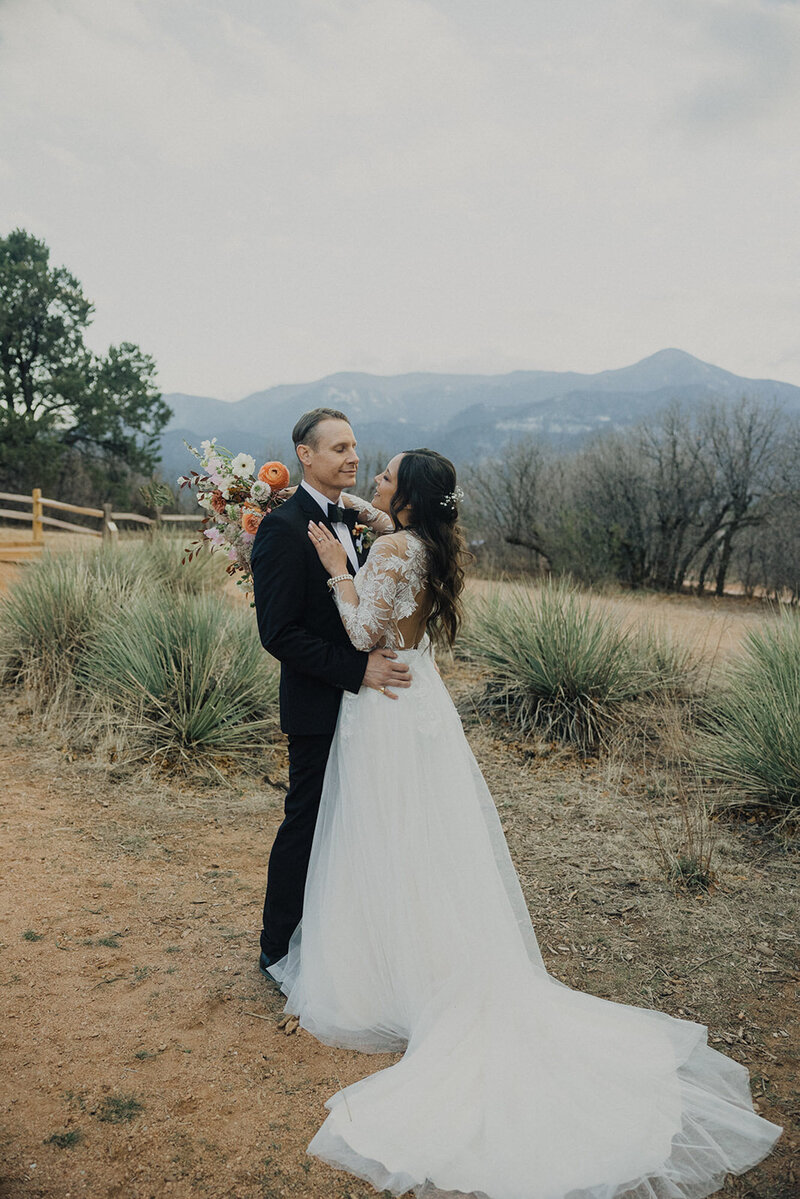 Black and white photo of married couple running at Garden of the Gods