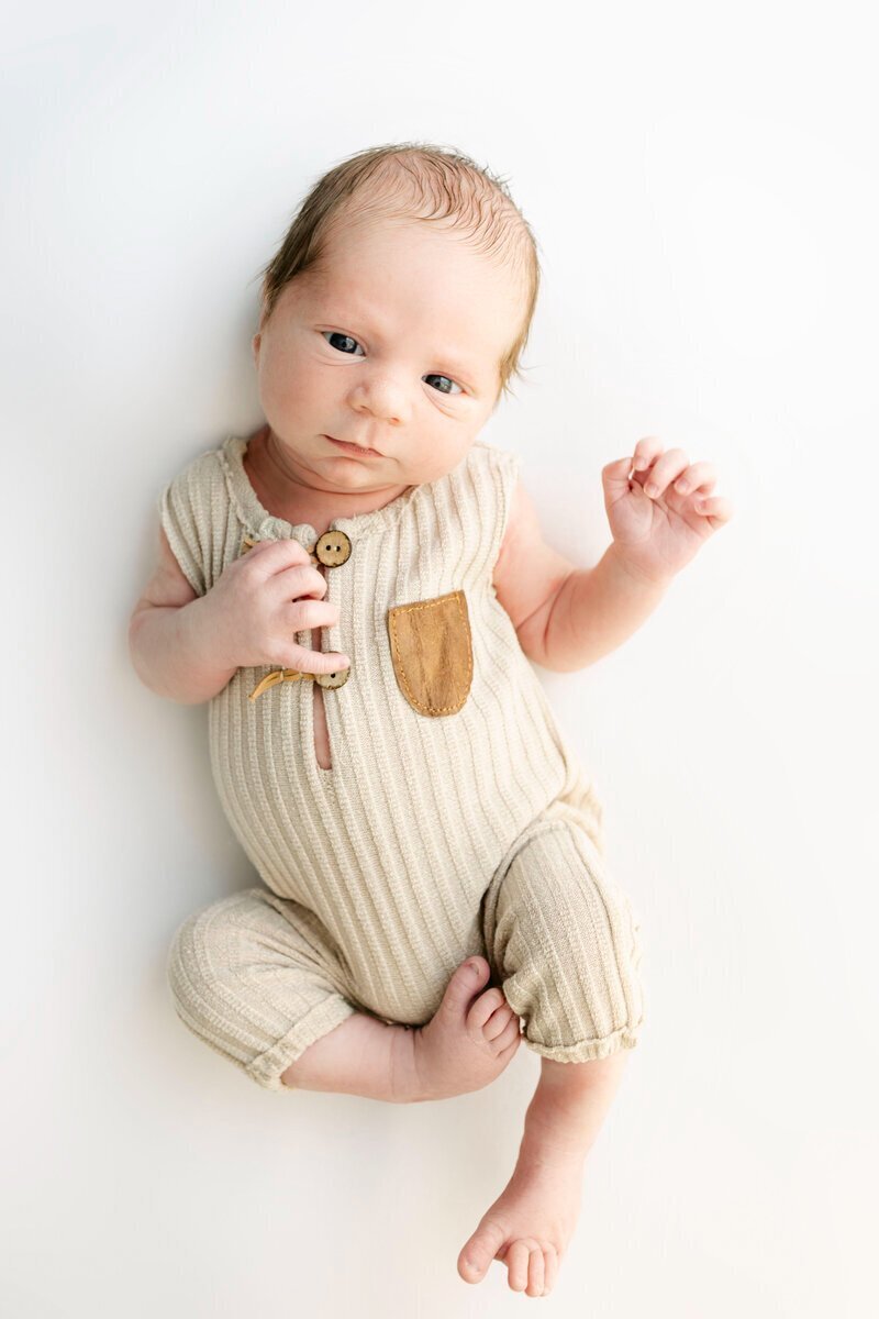 newborn photography nj of baby in beige onesie