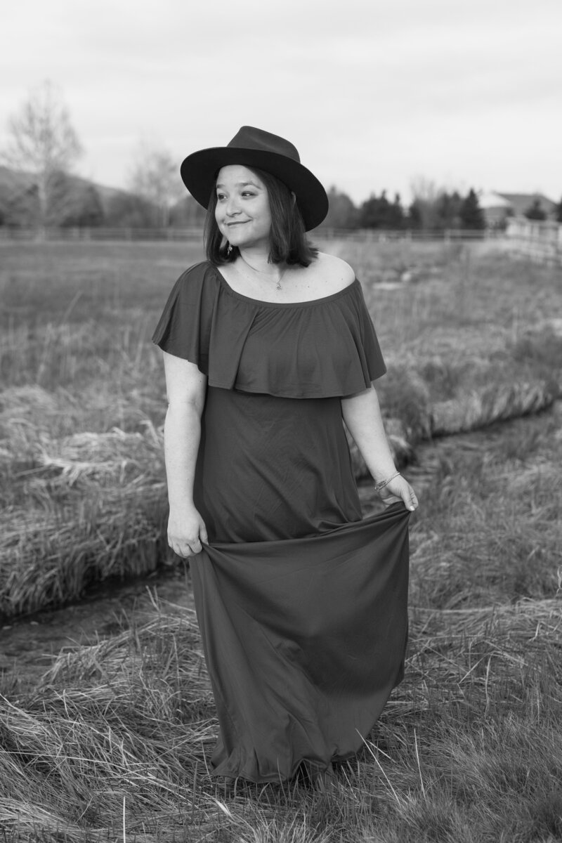black and white image Jennifer posing in field