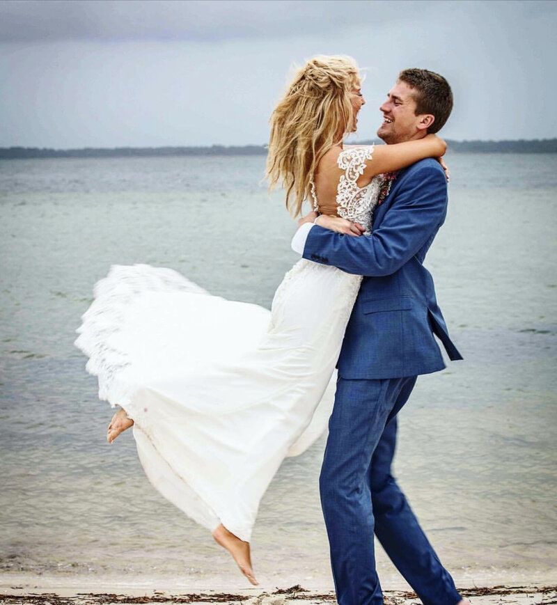Event Venue Palafox Wharf Waterfront couple at beach taking photos