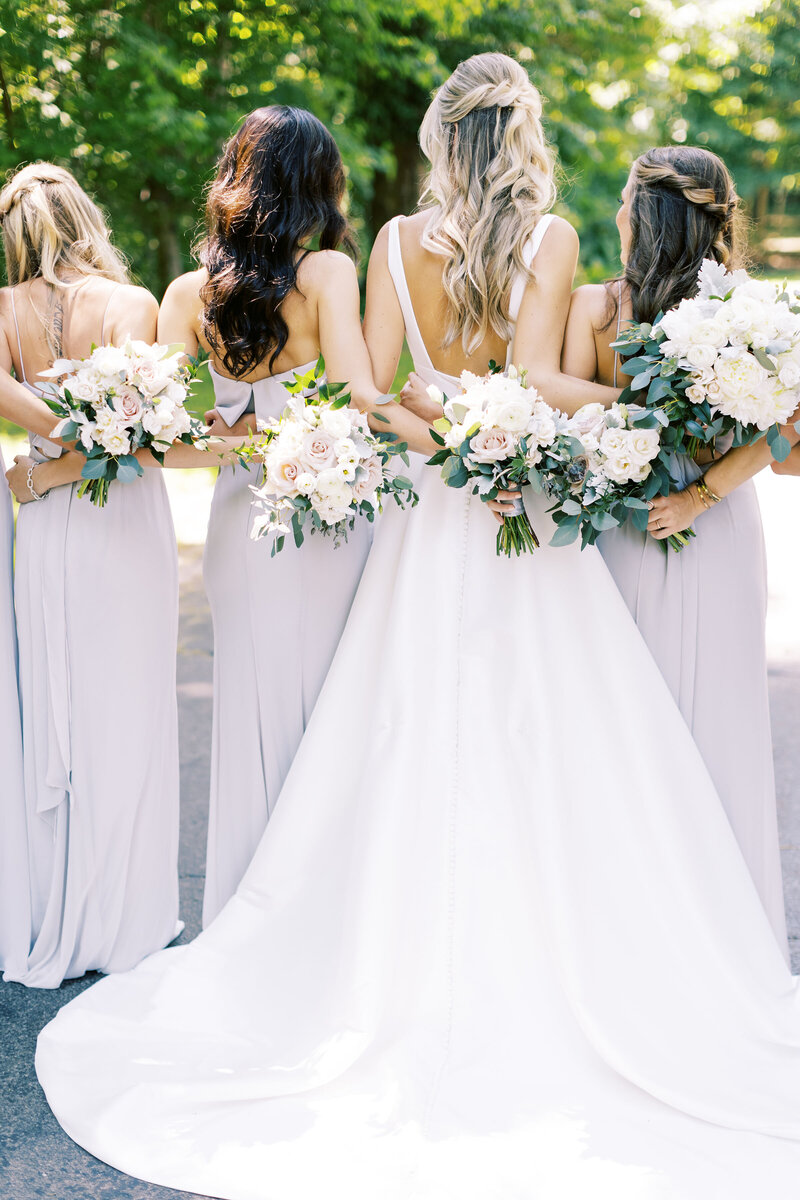 Samantha and her bridesmaids embrace for a portrait at the Morris Estate wedding in Niles, Michigan, photo by Cynthia Mae Grand Rapids Wedding Photographer